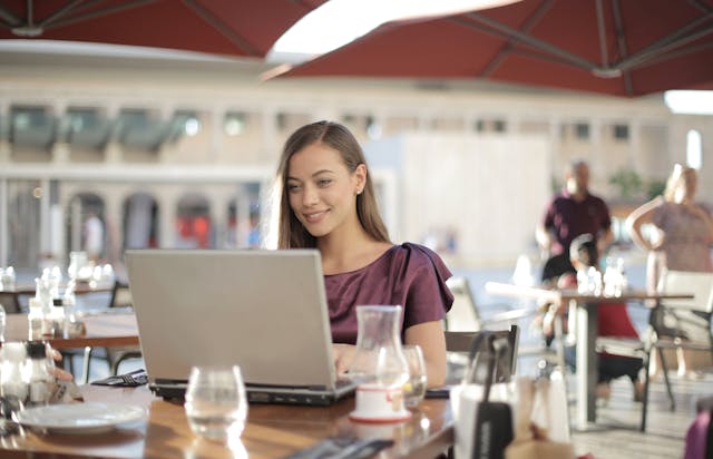 business women working in a cafe using a accounting software