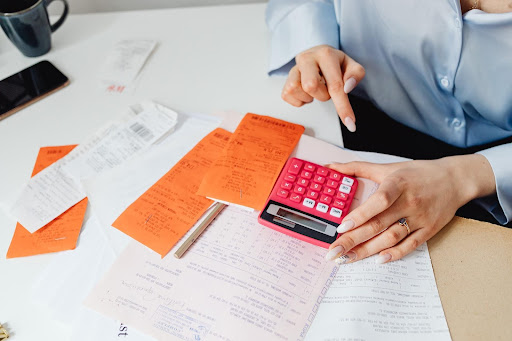 business women working on cloud bookkeeping with a calculator 