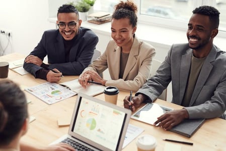 colleagues discussing business intelligence reporting in a conference room