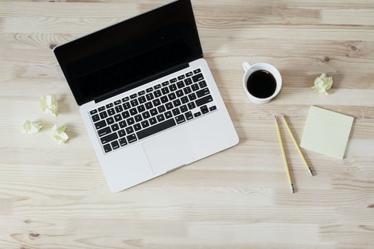 laptop and coffee to write a bookkeeping engagement letter 