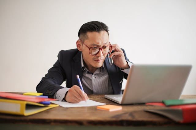 man talking on the phone and viewing business intelligence reporting  