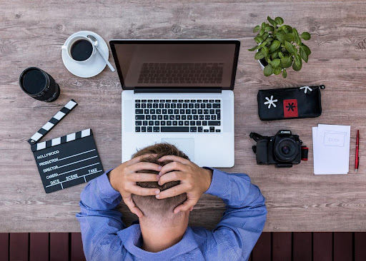 Man working on employee taxes using laptop 