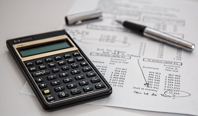 accountant working with calculator and documents 