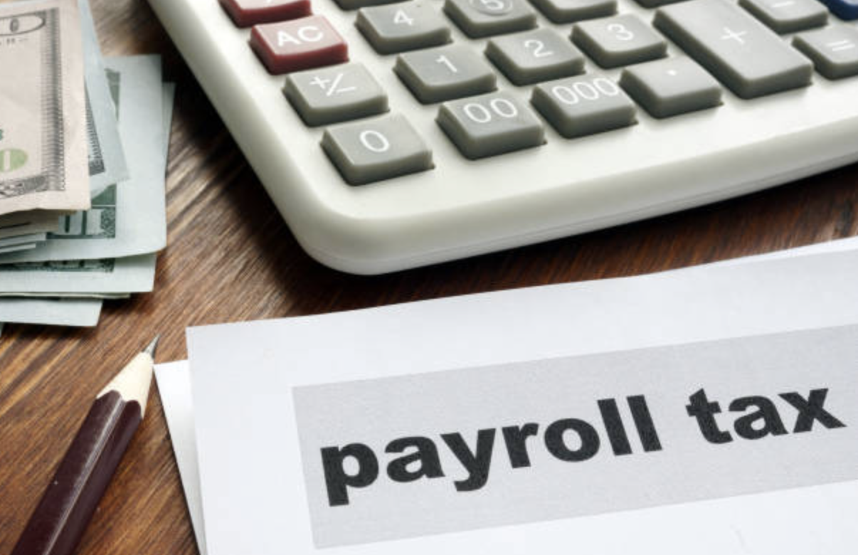 Calculator, money and payroll tax paper 