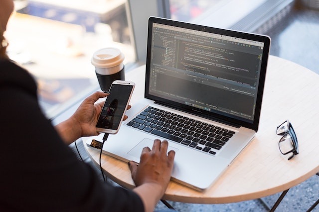 business person working with phone and laptop 