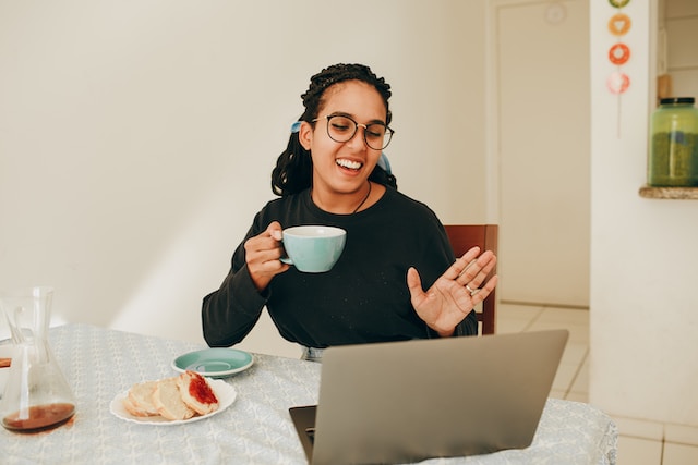 women drinking coffee with laptop working from home remotely
